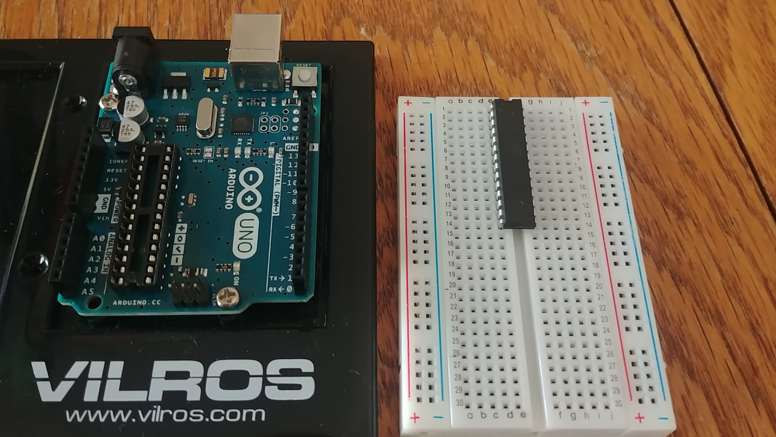 The Arduino Uno PCB, next to the ATmega328p placed on a breadboard